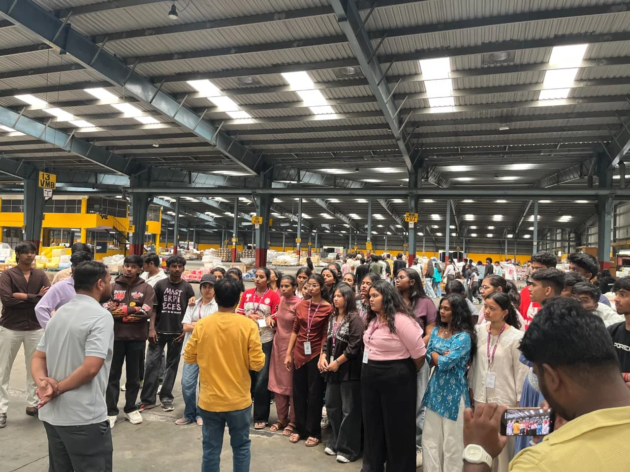 Students listening to a guide inside an industrial facility
